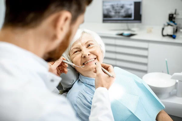older woman having her teeth checked by her dentist