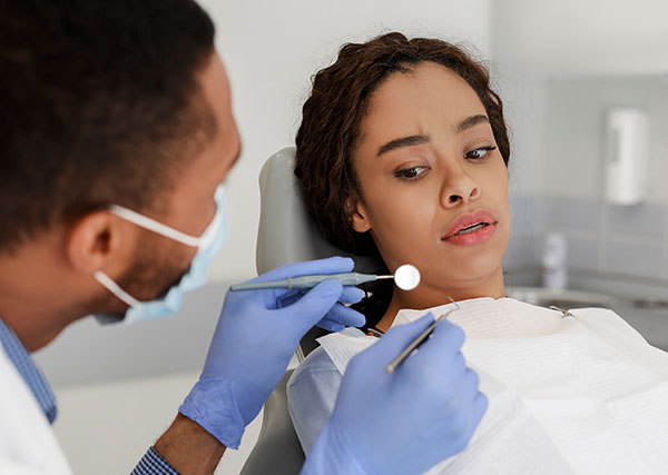 woman in the dental chair having dental anxiety